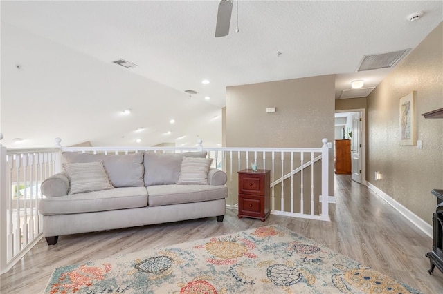 living room with lofted ceiling and light wood-type flooring