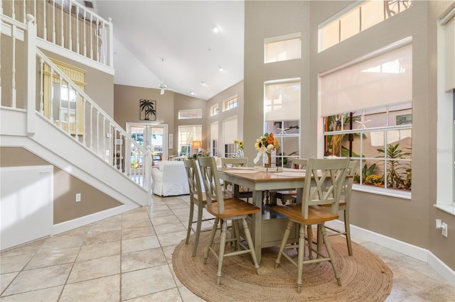 tiled dining area with a high ceiling