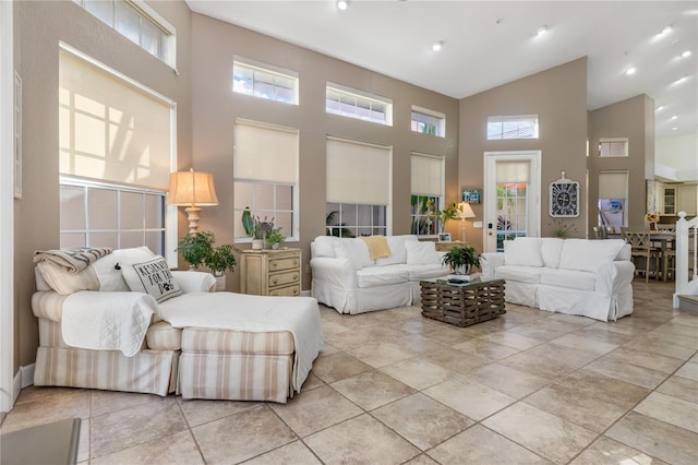 living room featuring a healthy amount of sunlight and a high ceiling