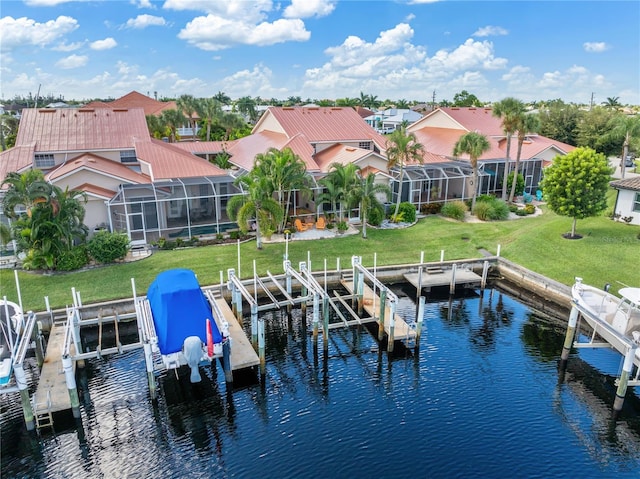 view of dock featuring a yard, a water view, and glass enclosure