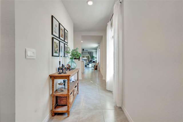 hall with light tile patterned floors