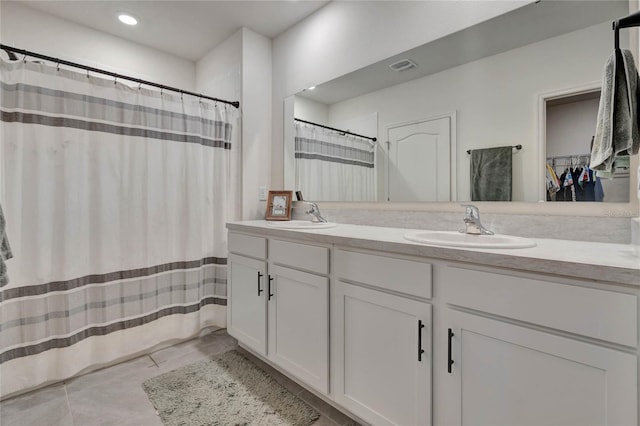 bathroom featuring tile patterned floors and vanity