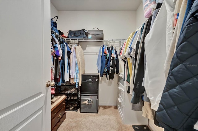 walk in closet featuring light carpet