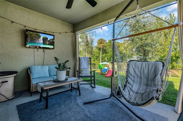 sunroom featuring ceiling fan