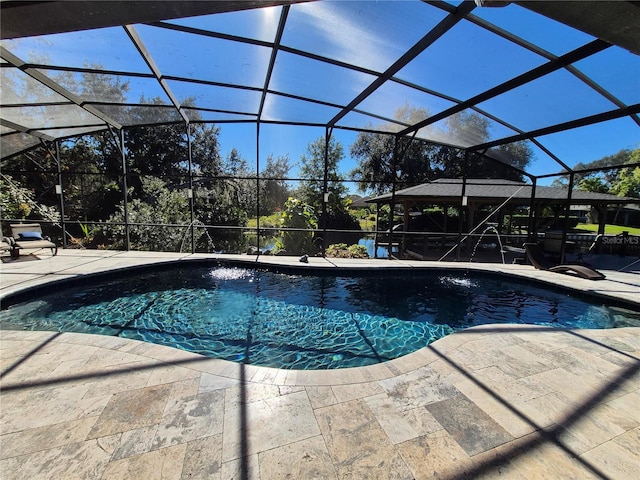 view of swimming pool featuring a patio, pool water feature, and glass enclosure