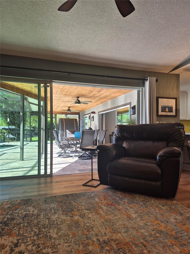 living room with hardwood / wood-style flooring, plenty of natural light, and a textured ceiling