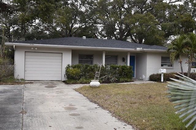 single story home with a front yard and a garage