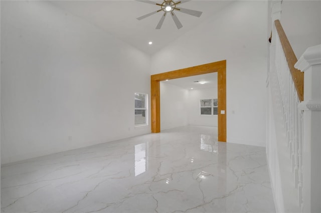 spare room featuring high vaulted ceiling and ceiling fan