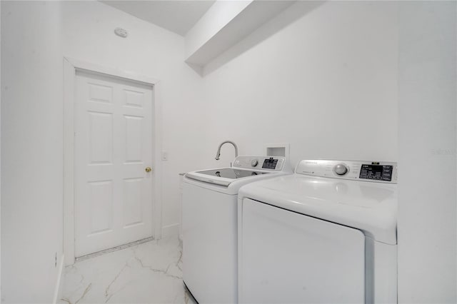 clothes washing area featuring washer and clothes dryer