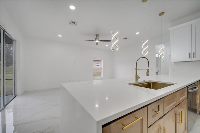 kitchen featuring white cabinetry, light brown cabinets, sink, hanging light fixtures, and ceiling fan