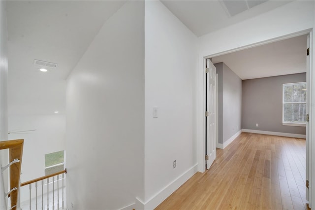 corridor with light hardwood / wood-style floors