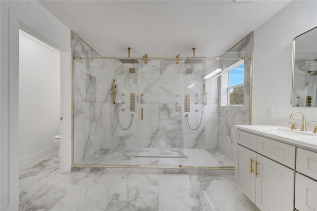 bathroom featuring a shower with shower door, a textured ceiling, toilet, and vanity