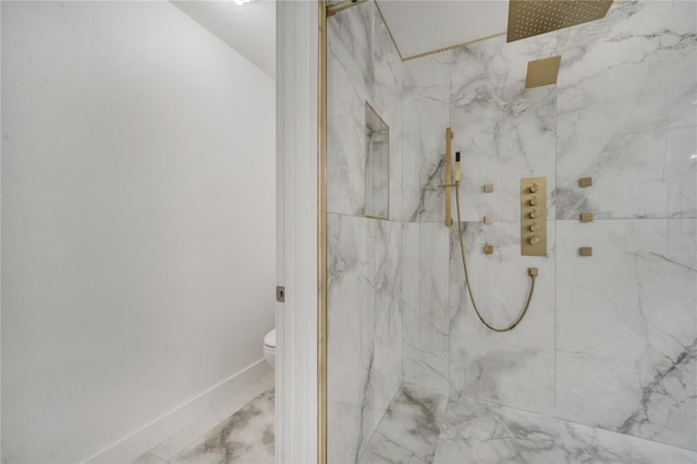 bathroom featuring toilet and tiled shower