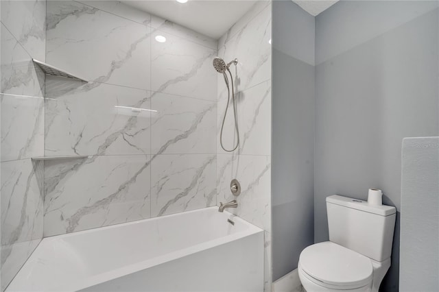 bathroom featuring toilet and tiled shower / bath