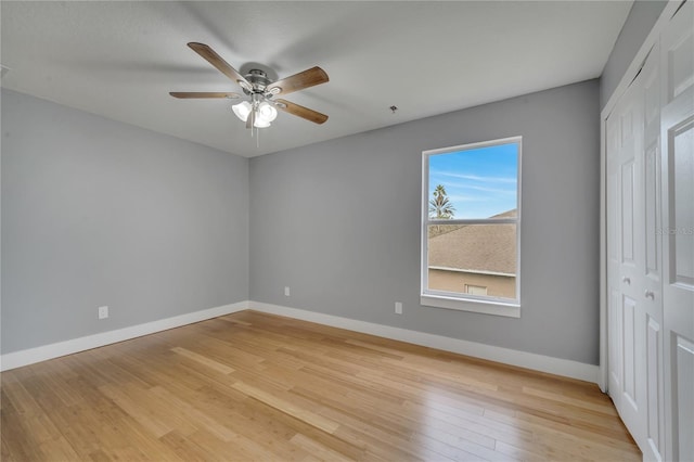 unfurnished bedroom featuring ceiling fan, a closet, and light hardwood / wood-style flooring