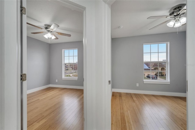 spare room featuring ceiling fan and light hardwood / wood-style flooring