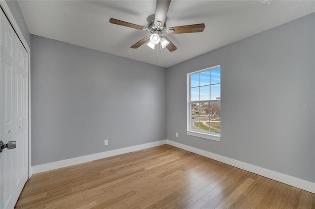 spare room featuring light hardwood / wood-style floors and ceiling fan