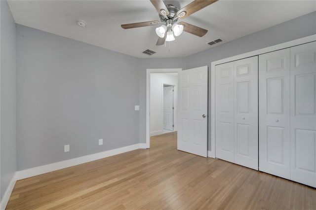 unfurnished bedroom featuring ceiling fan, light hardwood / wood-style floors, and a closet