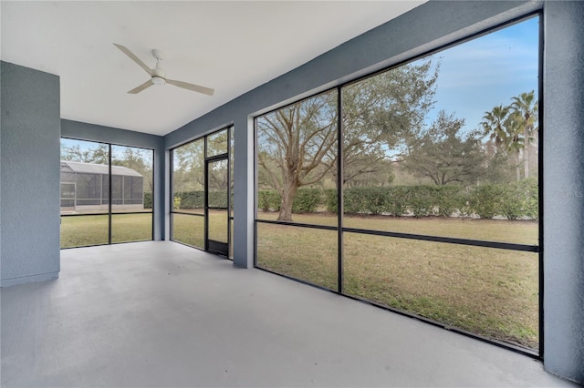 unfurnished sunroom with ceiling fan