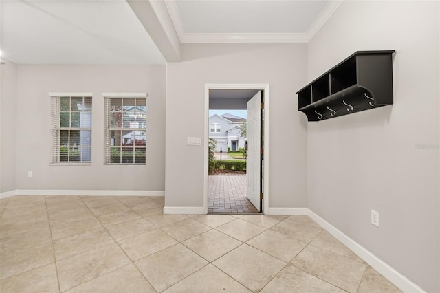 tiled foyer entrance featuring ornamental molding