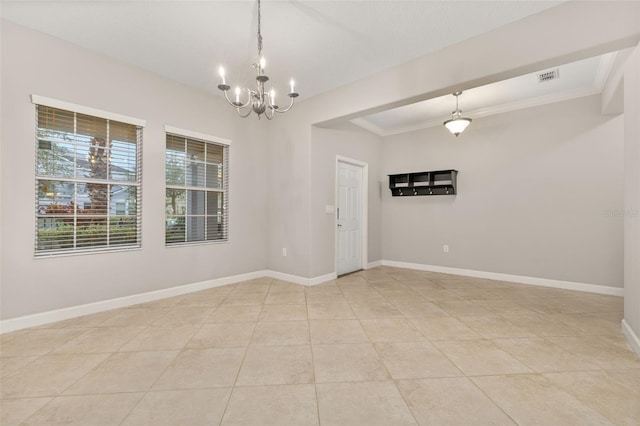 empty room with light tile patterned flooring, crown molding, and an inviting chandelier