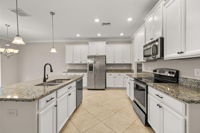 kitchen featuring white cabinetry, hanging light fixtures, an island with sink, and stainless steel appliances