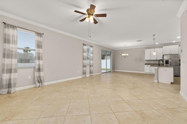 unfurnished living room featuring ceiling fan with notable chandelier, sink, light tile patterned floors, and crown molding