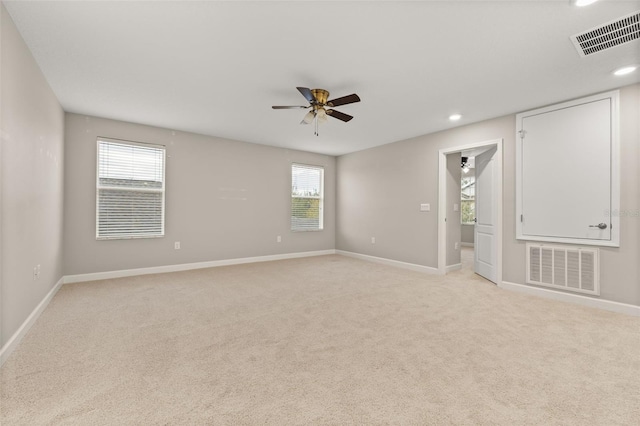 carpeted spare room featuring ceiling fan