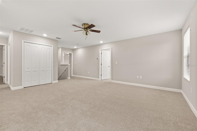 empty room with light carpet and ceiling fan