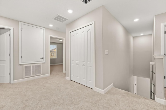 corridor with light colored carpet