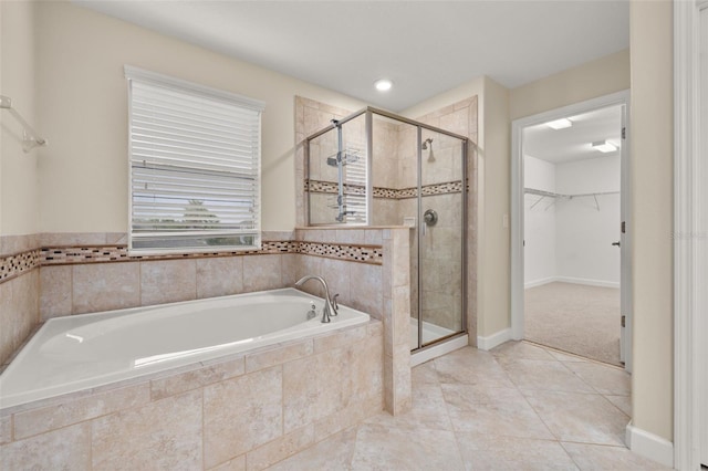 bathroom featuring tile patterned floors and separate shower and tub