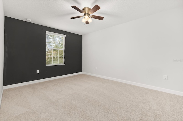 spare room with carpet and ceiling fan