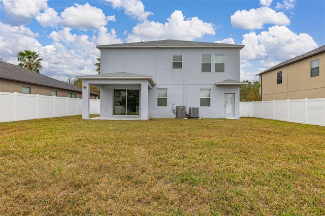 rear view of house with a yard, a patio, and central AC unit