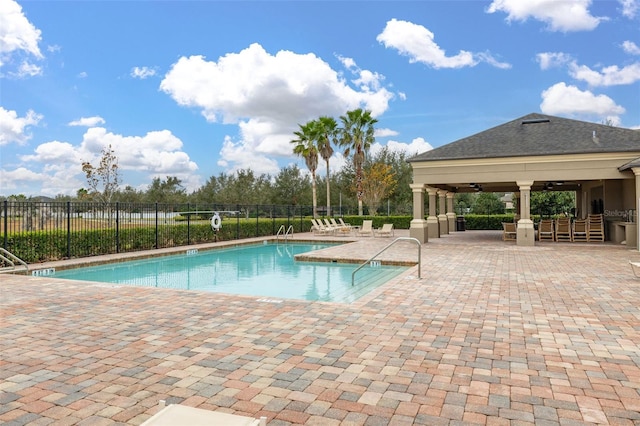 view of pool with a gazebo, ceiling fan, and a patio area