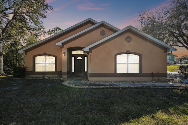 ranch-style home featuring a yard