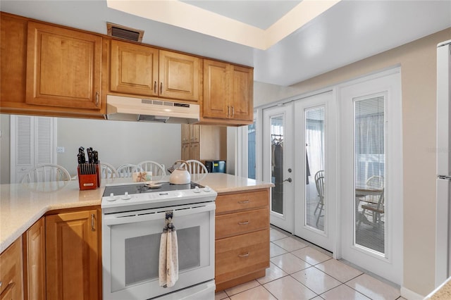 kitchen featuring white electric range, light tile patterned floors, and french doors