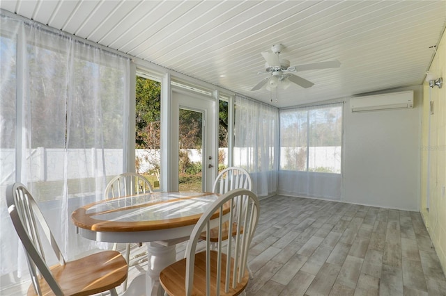 sunroom / solarium featuring ceiling fan and a wall mounted air conditioner