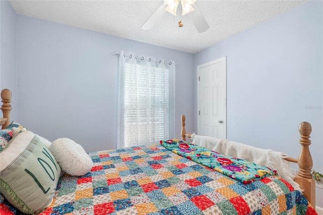 bedroom featuring a textured ceiling and ceiling fan