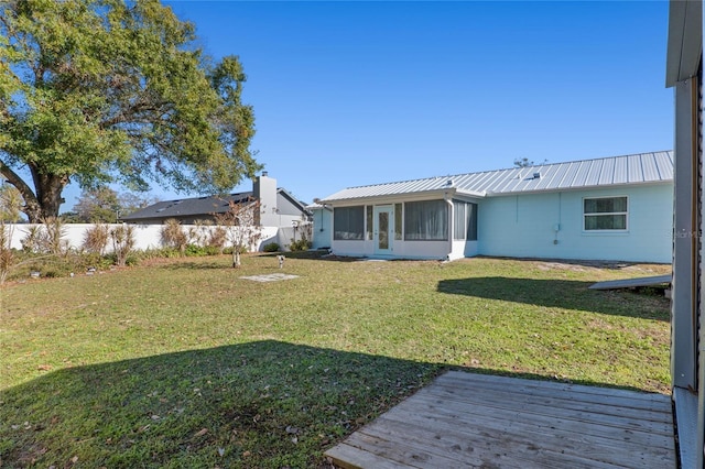 back of property featuring a sunroom and a yard