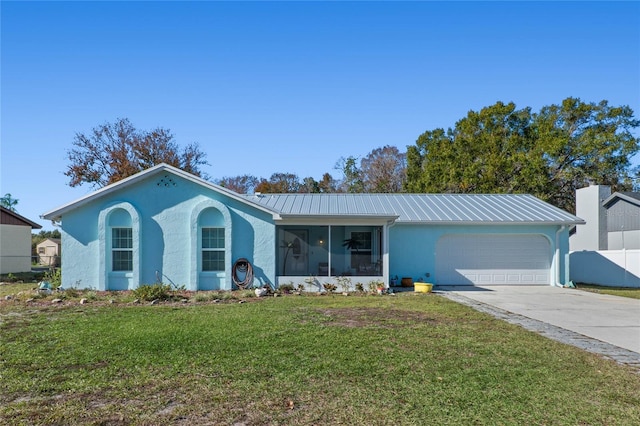 single story home featuring a sunroom, a garage, and a front lawn