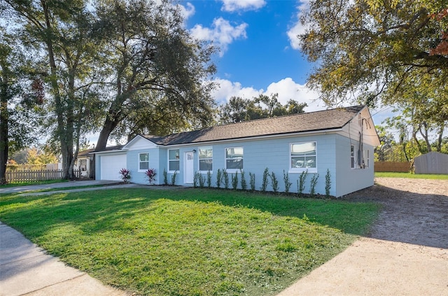 ranch-style house with a front yard and a garage