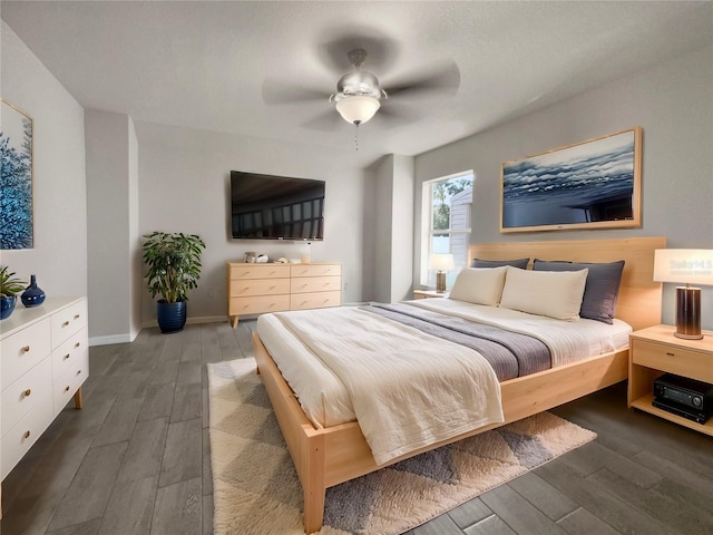 bedroom with ceiling fan and dark hardwood / wood-style floors