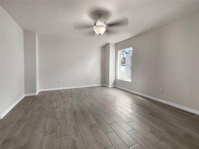 unfurnished room with dark hardwood / wood-style floors and ceiling fan