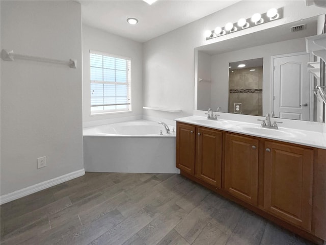 bathroom with vanity, plus walk in shower, and hardwood / wood-style flooring