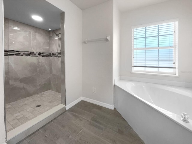 bathroom with separate shower and tub