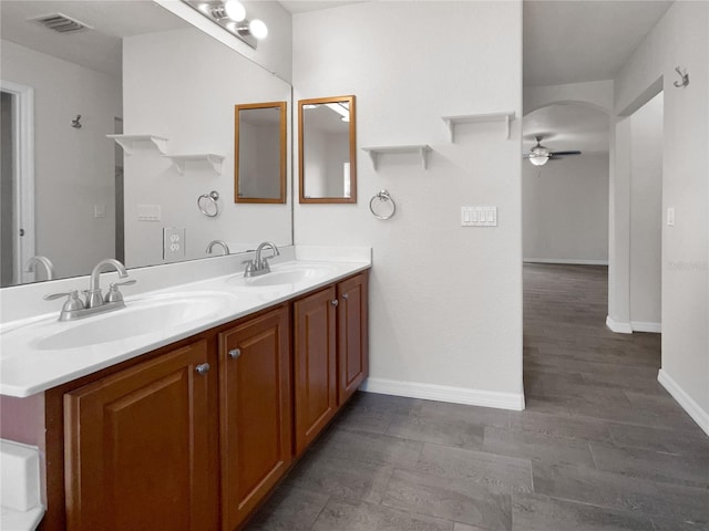 bathroom featuring hardwood / wood-style flooring, ceiling fan, and vanity