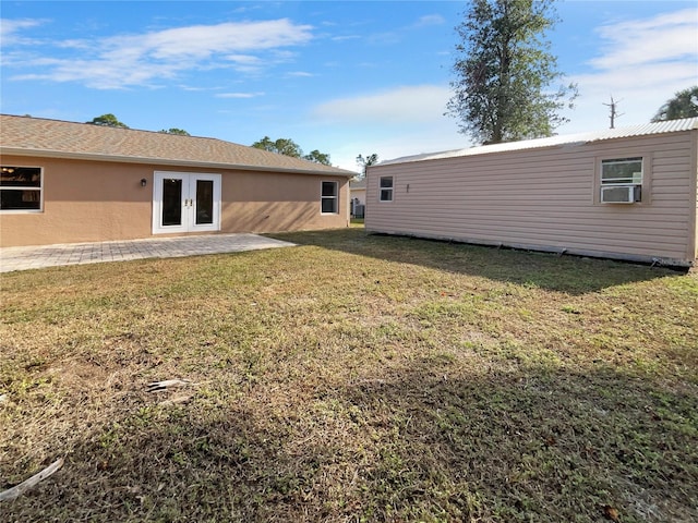 back of property featuring a lawn, cooling unit, a patio area, and french doors