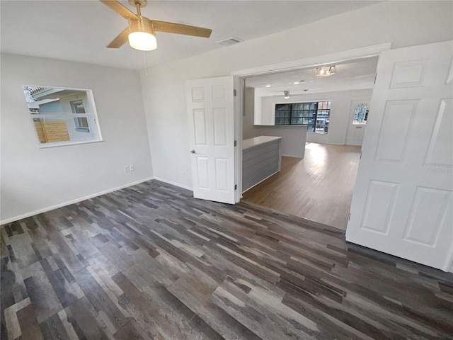 unfurnished room featuring dark hardwood / wood-style flooring and ceiling fan