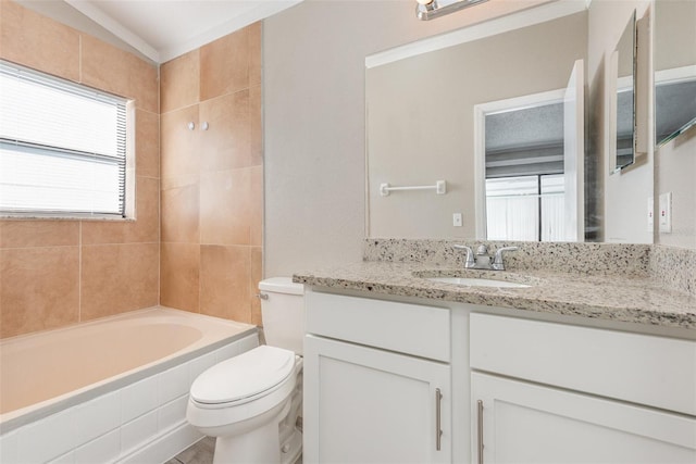 full bathroom featuring tiled shower / bath, vanity, and toilet