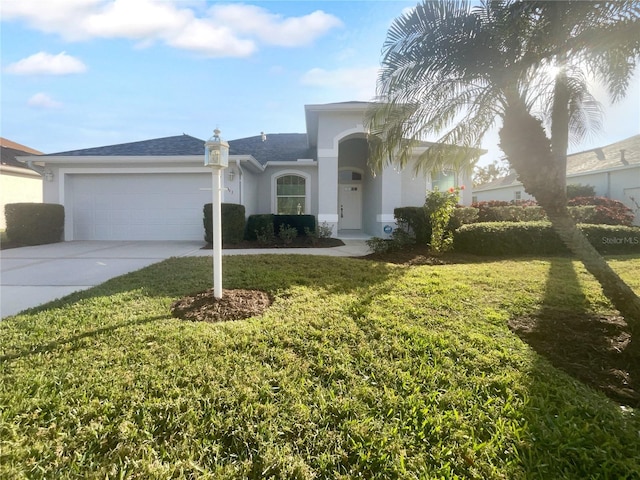 view of front of house with a front yard and a garage